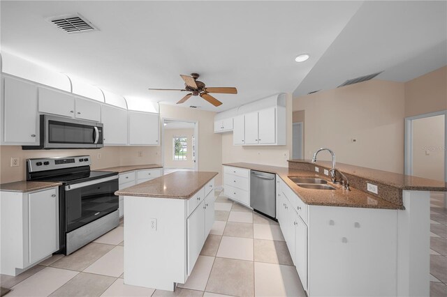 1314 SE 15th Ter, Cape Coral, FL 33990 - kitchen featuring stainless steel appliances, a sink, a peninsula, white cabinetry, and recessed lighting