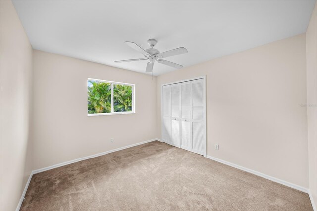 1314 SE 15th Ter, Cape Coral, FL 33990 - unfurnished bedroom with a closet, carpet floors, baseboards, and a ceiling fan