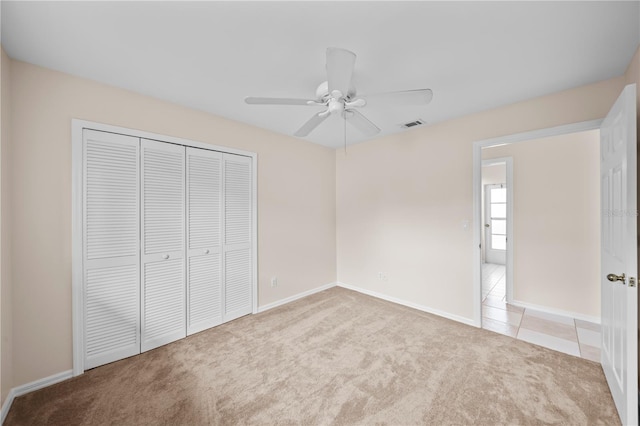 1314 SE 15th Ter, Cape Coral, FL 33990 - unfurnished bedroom with carpet flooring, a closet, baseboards, and a ceiling fan