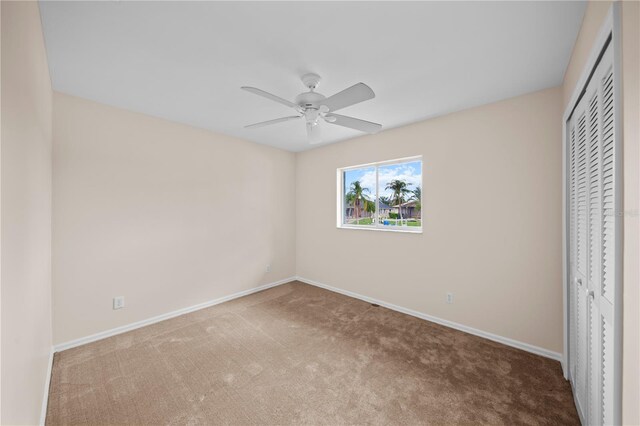 1314 SE 15th Ter, Cape Coral, FL 33990 - unfurnished bedroom featuring carpet, baseboards, a closet, and ceiling fan