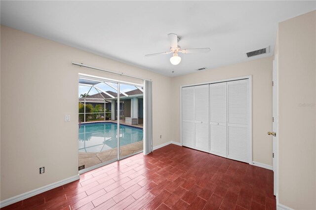 1314 SE 15th Ter, Cape Coral, FL 33990 - unfurnished bedroom featuring access to exterior, dark wood finished floors, a sunroom, baseboards, and a closet