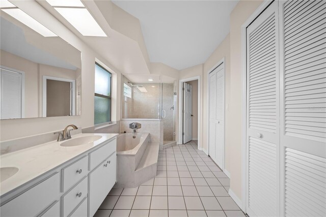 1314 SE 15th Ter, Cape Coral, FL 33990 - full bath featuring a closet, a stall shower, double vanity, a garden tub, and tile patterned floors