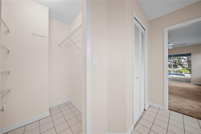1314 SE 15th Ter, Cape Coral, FL 33990 - walk in closet with light tile patterned floors, light carpet, and a ceiling fan