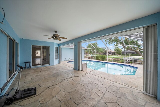 1314 SE 15th Ter, Cape Coral, FL 33990 - outdoor pool featuring ceiling fan, a patio area, and glass enclosure