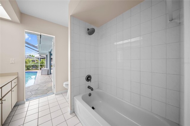 1314 SE 15th Ter, Cape Coral, FL 33990 - bathroom featuring toilet, vanity, bathing tub / shower combination, tile patterned floors, and baseboards