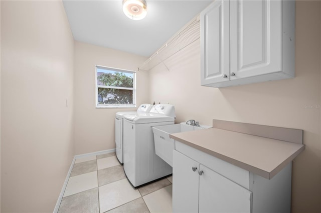 1314 SE 15th Ter, Cape Coral, FL 33990 - laundry area with cabinet space, washing machine and clothes dryer, baseboards, and light tile patterned flooring