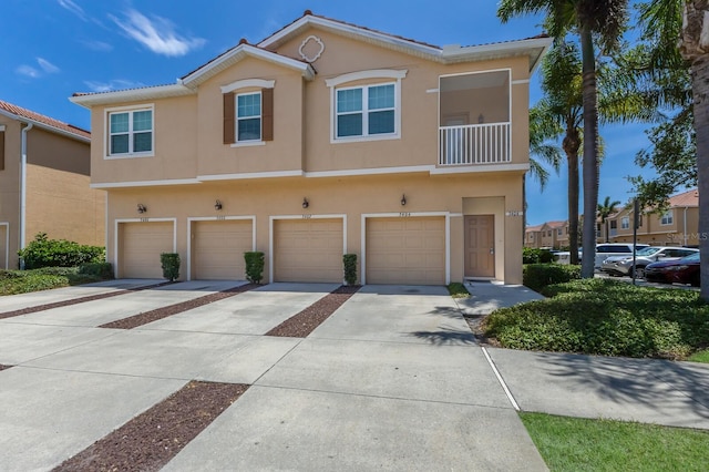 3402 Parkridge Cir, Sarasota, FL 34243 - multi unit property featuring stucco siding, driveway, and a garage