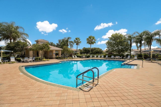3402 Parkridge Cir, Sarasota, FL 34243 - community pool featuring a patio area
