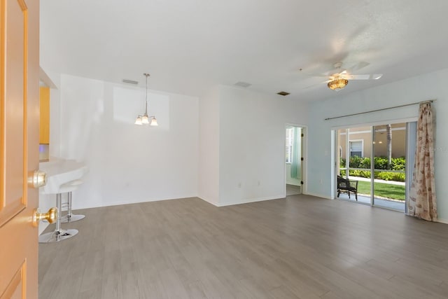 3402 Parkridge Cir, Sarasota, FL 34243 - unfurnished living room with a chandelier, wood finished floors, a ceiling fan, and baseboards