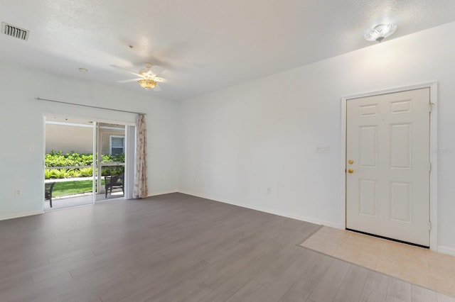 3402 Parkridge Cir, Sarasota, FL 34243 - spare room with wood finished floors, ceiling fan, and baseboards