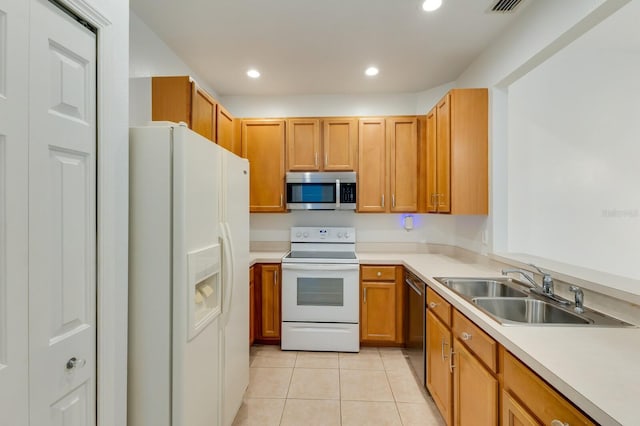 3402 Parkridge Cir, Sarasota, FL 34243 - kitchen featuring stainless steel appliances, a sink, light tile patterned floors, light countertops, and recessed lighting