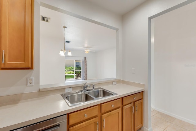 3402 Parkridge Cir, Sarasota, FL 34243 - kitchen featuring a sink, dishwasher, light countertops, and light tile patterned floors