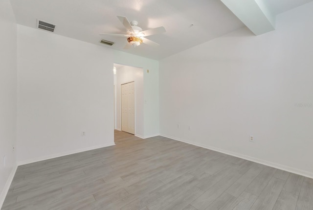 3402 Parkridge Cir, Sarasota, FL 34243 - spare room with ceiling fan, light wood-type flooring, vaulted ceiling, and baseboards