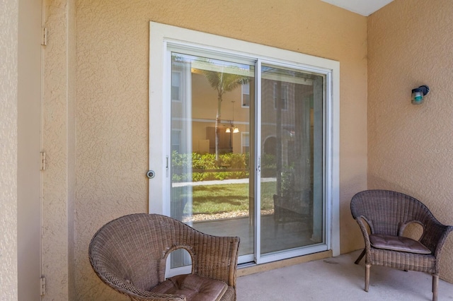 3402 Parkridge Cir, Sarasota, FL 34243 - doorway to outside featuring a textured wall, plenty of natural light, and carpet