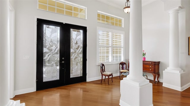 7081 Grassland Ct, Sarasota, FL 34241 - entrance foyer with ornate columns, wood finished floors, french doors, and crown molding