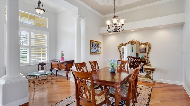 7081 Grassland Ct, Sarasota, FL 34241 - dining area featuring decorative columns, crown molding, light wood finished floors, a chandelier, and recessed lighting