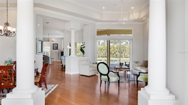 7081 Grassland Ct, Sarasota, FL 34241 - living area featuring a ceiling fan, decorative columns, wood finished floors, crown molding, and recessed lighting