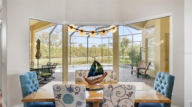 7081 Grassland Ct, Sarasota, FL 34241 - dining room featuring baseboards and a chandelier