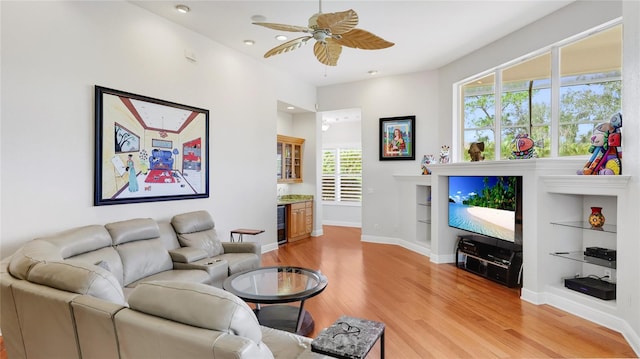 7081 Grassland Ct, Sarasota, FL 34241 - living room with light wood-style floors, ceiling fan, wine cooler, recessed lighting, and built in features