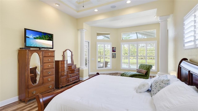 7081 Grassland Ct, Sarasota, FL 34241 - bedroom with decorative columns, wood finished floors, a towering ceiling, and recessed lighting