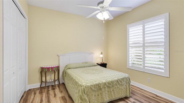 7081 Grassland Ct, Sarasota, FL 34241 - bedroom with a closet, wood finished floors, and a ceiling fan