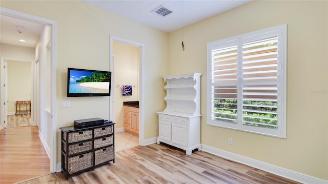 7081 Grassland Ct, Sarasota, FL 34241 - bedroom featuring light wood-style flooring and connected bathroom