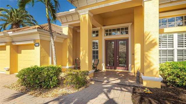 7081 Grassland Ct, Sarasota, FL 34241 - entrance to property featuring french doors, stucco siding, and a garage