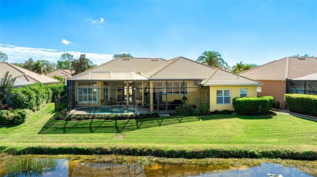 7081 Grassland Ct, Sarasota, FL 34241 - back of house with a lanai, a lawn, an outdoor pool, stucco siding, and a tile roof