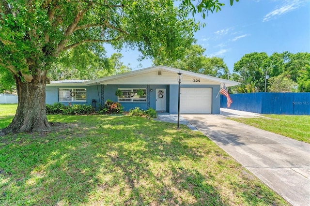 304 34th St W, Bradenton, FL 34205 - ranch-style house featuring a garage, concrete driveway, and stucco siding