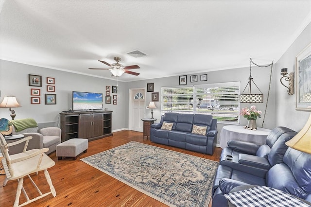 304 34th St W, Bradenton, FL 34205 - living area featuring wood finished floors, a ceiling fan, and crown molding