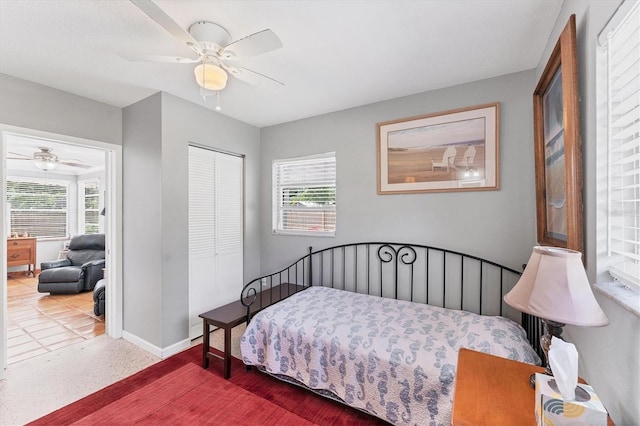 304 34th St W, Bradenton, FL 34205 - bedroom featuring multiple windows, a closet, baseboards, and a ceiling fan