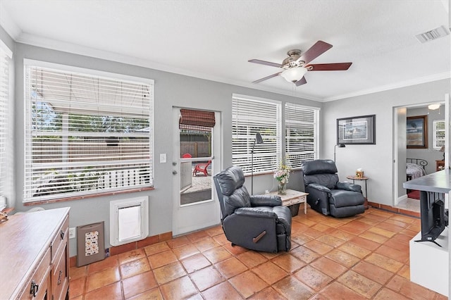 304 34th St W, Bradenton, FL 34205 - living area with ceiling fan, ornamental molding, and light tile patterned floors