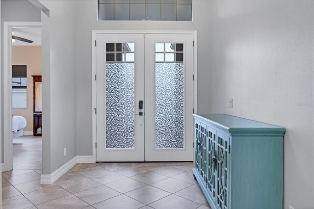 6636 35th Ct E, Sarasota, FL 34243 - entryway featuring french doors, tile patterned floors, and baseboards