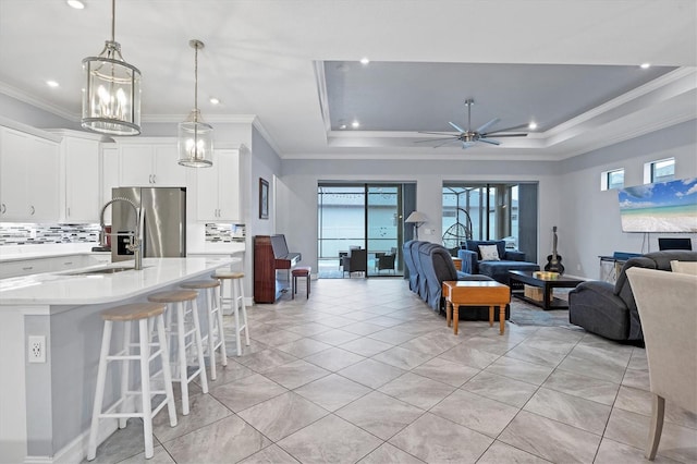 6636 35th Ct E, Sarasota, FL 34243 - living area with ornamental molding, a ceiling fan, a raised ceiling, recessed lighting, and light tile patterned floors