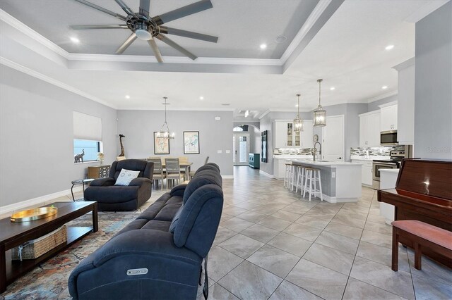 6636 35th Ct E, Sarasota, FL 34243 - living room featuring a raised ceiling, a ceiling fan, recessed lighting, ornamental molding, and light tile patterned flooring