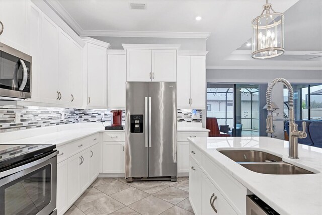 6636 35th Ct E, Sarasota, FL 34243 - kitchen with stainless steel appliances, a sink, crown molding, healthy amount of natural light, and tasteful backsplash