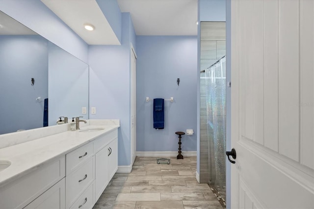 6636 35th Ct E, Sarasota, FL 34243 - full bath with double vanity, wood finished floors, baseboards, and a shower with curtain