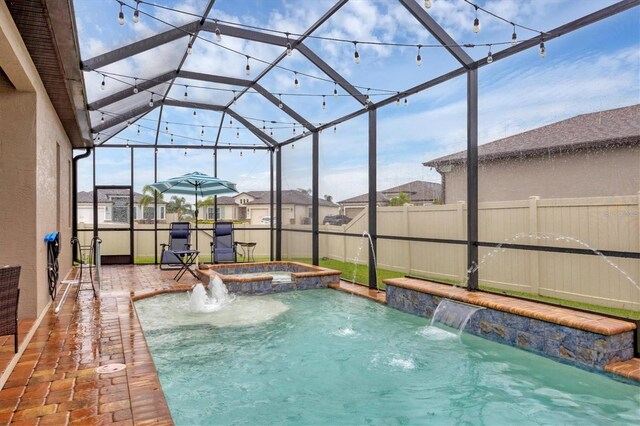 6636 35th Ct E, Sarasota, FL 34243 - view of swimming pool with a fenced backyard, a pool with connected hot tub, a patio, and a lanai