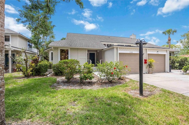 7926 Woodpointe Ct Unit 29, Sarasota, FL 34238 - view of front of property featuring a garage, concrete driveway, a front lawn, and a shingled roof
