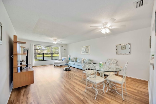 7926 Woodpointe Ct Unit 29, Sarasota, FL 34238 - living room featuring a ceiling fan, wood finished floors, and baseboards