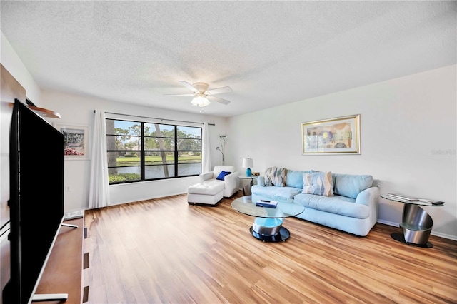 7926 Woodpointe Ct Unit 29, Sarasota, FL 34238 - living area with a ceiling fan, a textured ceiling, and wood finished floors