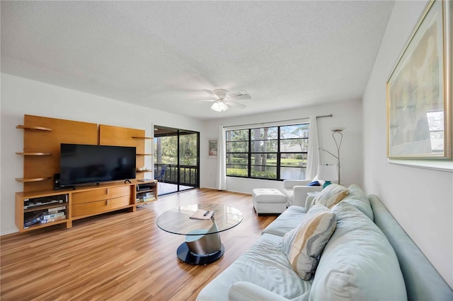 7926 Woodpointe Ct Unit 29, Sarasota, FL 34238 - living room with ceiling fan, a textured ceiling, and light wood-style floors
