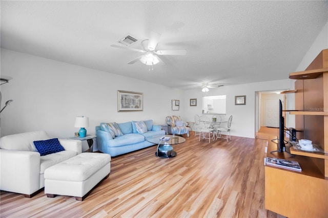 7926 Woodpointe Ct Unit 29, Sarasota, FL 34238 - living area with ceiling fan, light wood-type flooring, and a textured ceiling