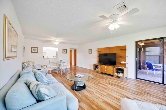 7926 Woodpointe Ct Unit 29, Sarasota, FL 34238 - living area with a ceiling fan, wood finished floors, and a textured ceiling