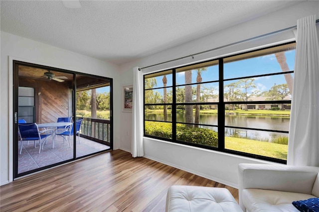 7926 Woodpointe Ct Unit 29, Sarasota, FL 34238 - interior space with wood finished floors, a water view, a textured ceiling, and ceiling fan