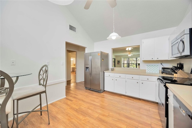 7926 Woodpointe Ct Unit 29, Sarasota, FL 34238 - kitchen with stainless steel appliances, ceiling fan, light countertops, white cabinetry, and high vaulted ceiling