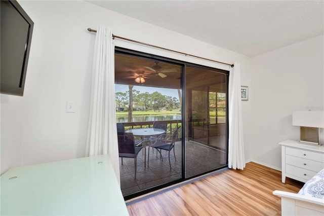 7926 Woodpointe Ct Unit 29, Sarasota, FL 34238 - dining space featuring light wood-style floors, a water view, and baseboards
