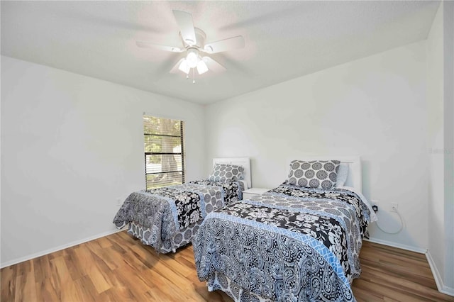 7926 Woodpointe Ct Unit 29, Sarasota, FL 34238 - bedroom featuring wood finished floors, baseboards, and a ceiling fan