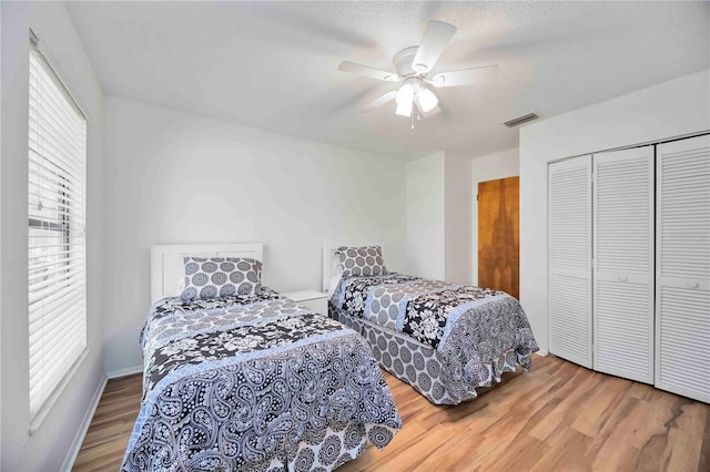 7926 Woodpointe Ct Unit 29, Sarasota, FL 34238 - bedroom featuring wood finished floors, a closet, a ceiling fan, and a textured ceiling