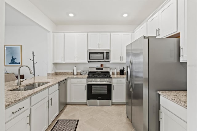 14835 Lyla Ter, Bradenton, FL 34211 - kitchen featuring stainless steel appliances, a sink, white cabinetry, light stone counters, and light tile patterned floors